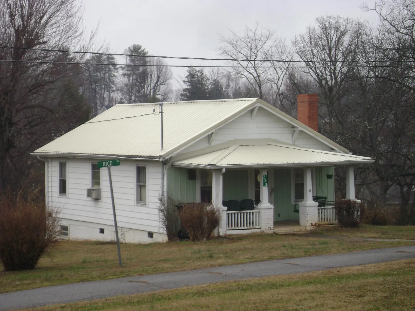 White metal roof on a craftsman bungalow at a street corner in Hillsdale